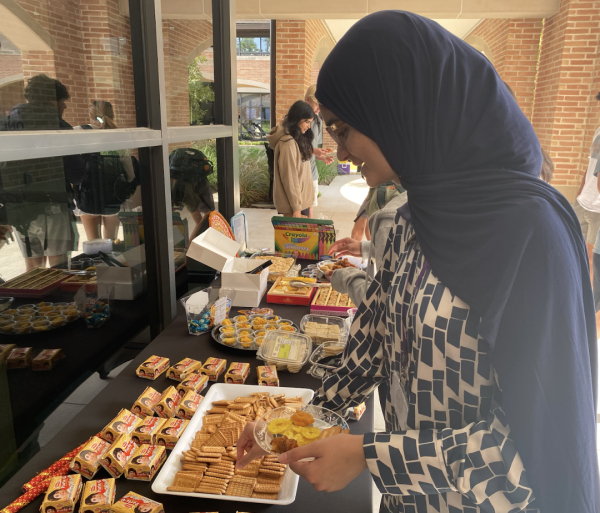 Junior Unaisah Saeed takes a Parle-G biscuit from the dessert section of the South Asian Heritage Club Diwali feast. Parle-G is a popular Indian snack that is enjoyed globally. “My favorite part of the Diwali feast was definitely the food. There's always an awesome variety of snacks and dishes to try,” Saeed said.